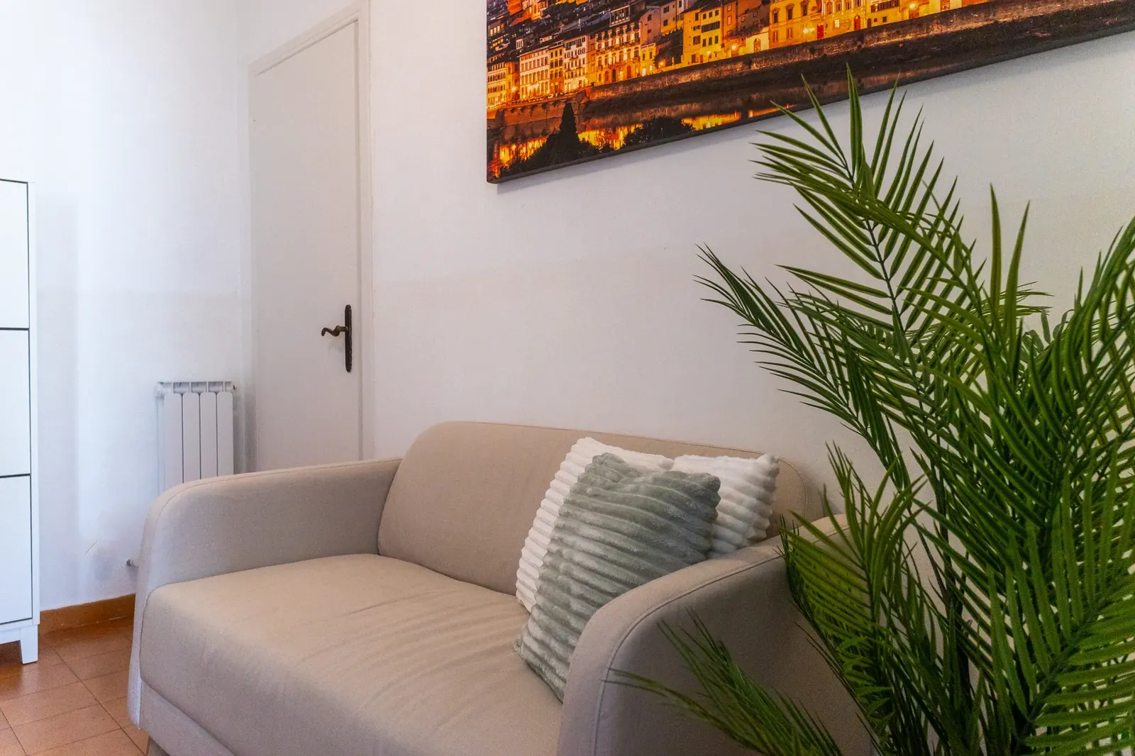 Soggiorno di Emy Apartment con divano e quadro di Firenze